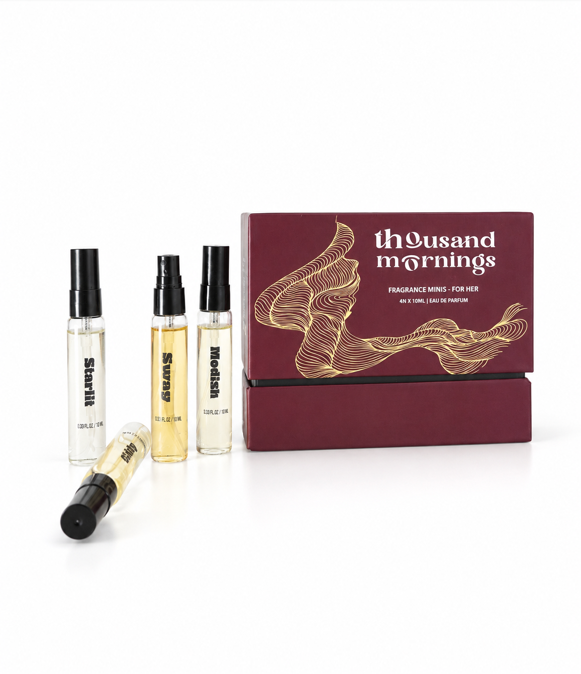A fragrance gift set by Thousand Mornings on a white background, featuring a dark burgundy box with gold wave graphics and four small perfume sample vials, including one vial lying in front.